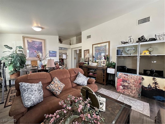 living room featuring visible vents and wood finished floors