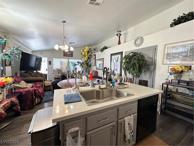 kitchen featuring gray cabinetry, lofted ceiling, black dishwasher, a notable chandelier, and a sink