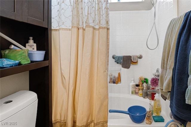 bathroom featuring shower / bath combo with shower curtain and toilet