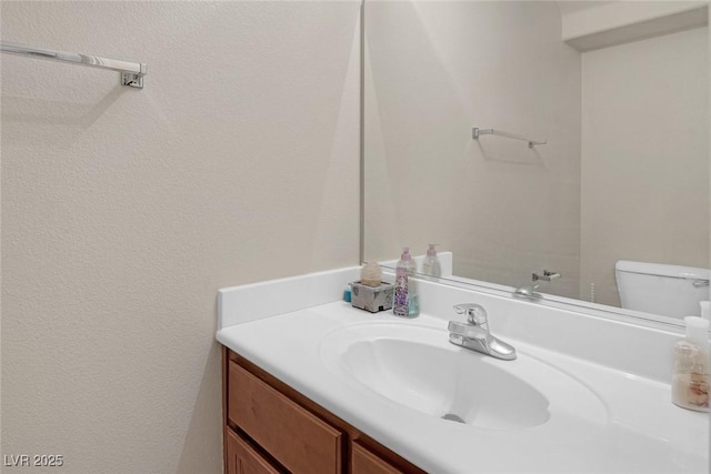 bathroom featuring toilet and vanity