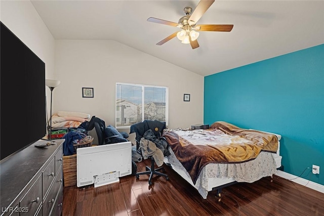 bedroom featuring baseboards, dark wood-type flooring, ceiling fan, and vaulted ceiling