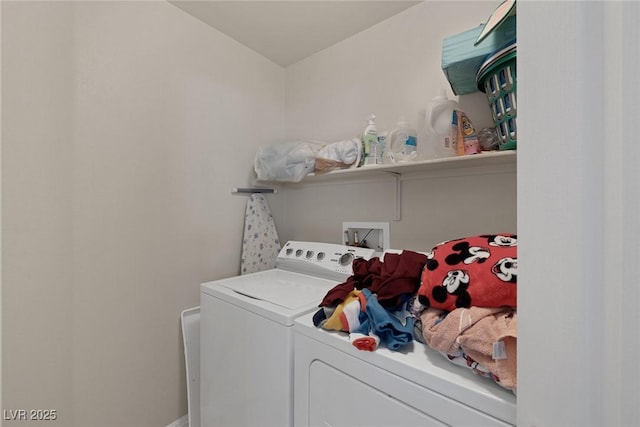 laundry room featuring separate washer and dryer and laundry area