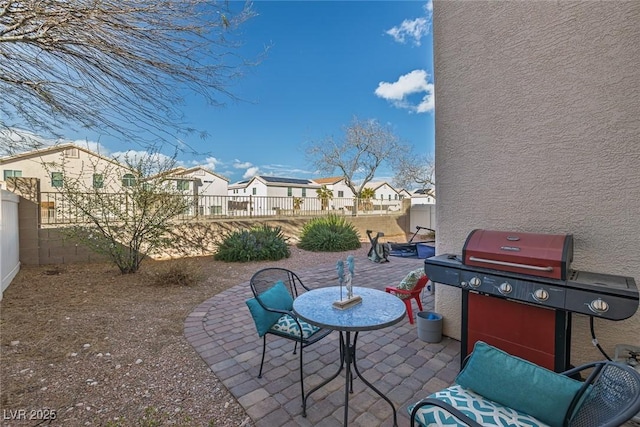 view of patio with a residential view, a grill, and a fenced backyard