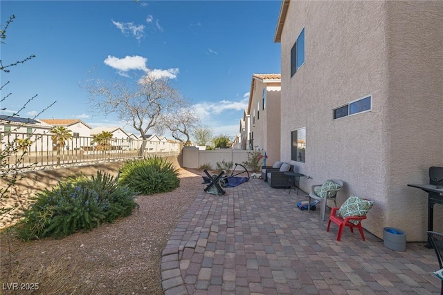 view of patio / terrace with a fenced backyard and a residential view