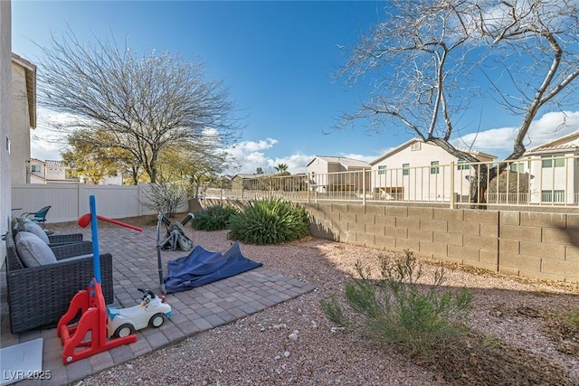 view of yard featuring a fenced backyard, a residential view, and a patio