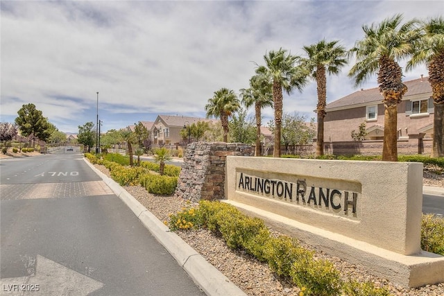 community / neighborhood sign with a residential view