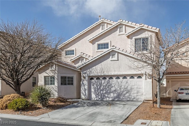 view of front facade with stucco siding, a garage, concrete driveway, and a tiled roof