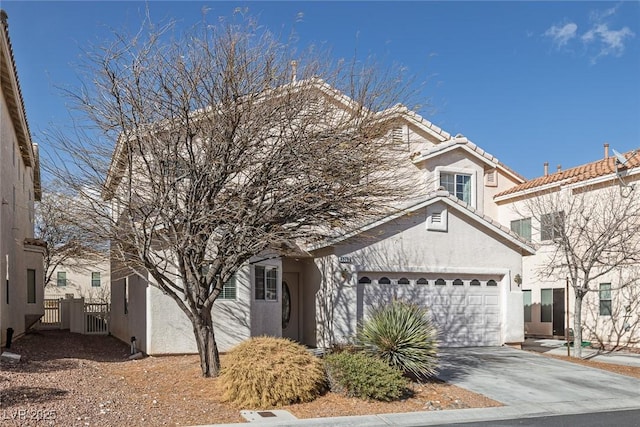 view of front of home featuring stucco siding, driveway, a tile roof, and a garage