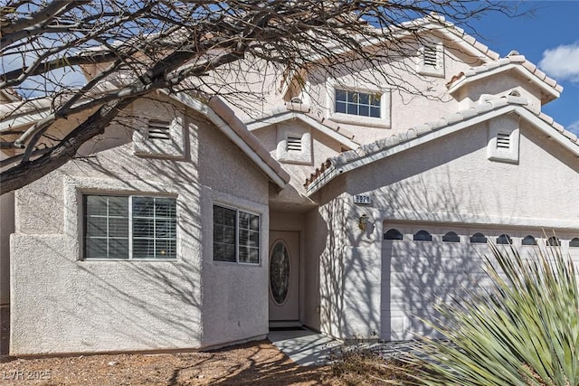 view of front of home featuring a garage and stucco siding