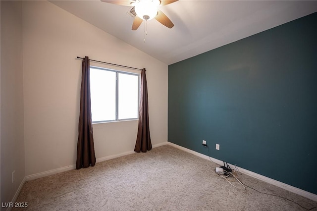 empty room featuring baseboards, ceiling fan, carpet flooring, and vaulted ceiling