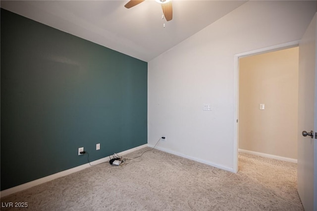 empty room featuring baseboards, a ceiling fan, carpet, and vaulted ceiling