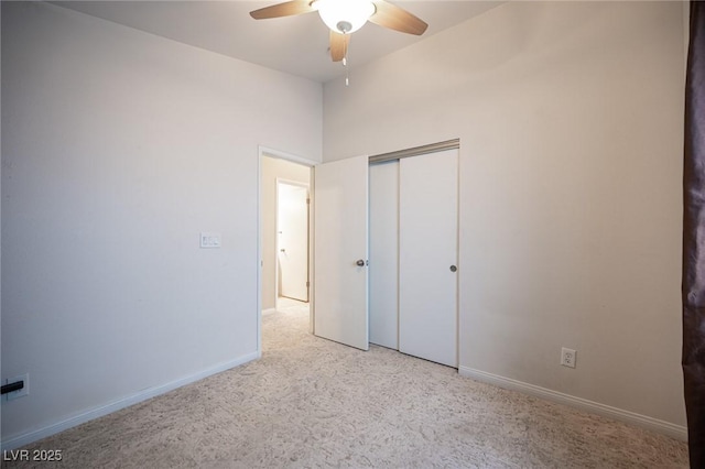 unfurnished bedroom featuring a closet, baseboards, ceiling fan, and carpet flooring