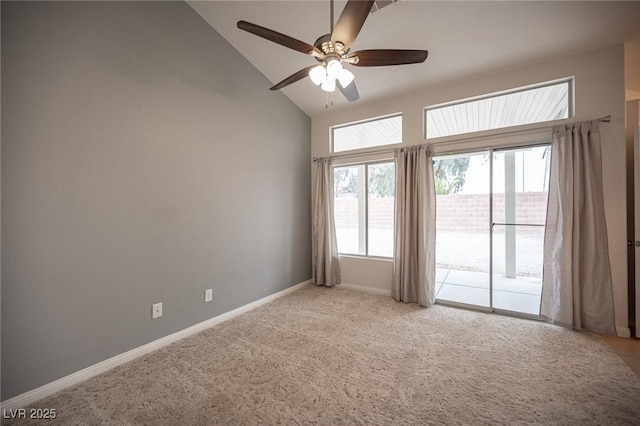 empty room featuring light carpet, high vaulted ceiling, baseboards, and a ceiling fan