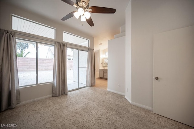 spare room featuring carpet flooring, baseboards, and a ceiling fan