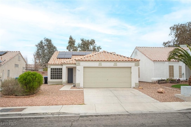 mediterranean / spanish house featuring a garage, concrete driveway, stucco siding, and a tile roof