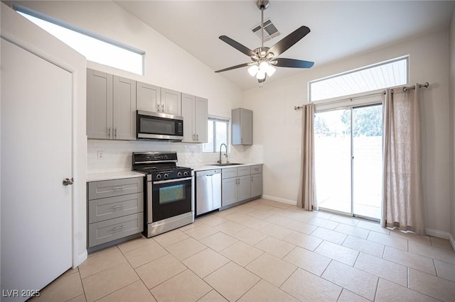 kitchen with visible vents, appliances with stainless steel finishes, light countertops, and gray cabinetry