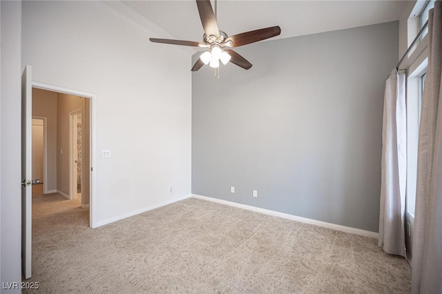 spare room with baseboards, a ceiling fan, and carpet floors