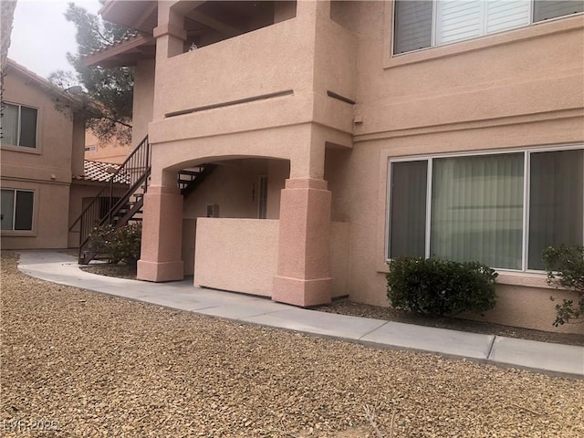 doorway to property featuring stucco siding