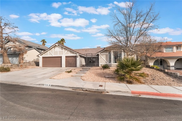 view of front of property featuring an attached garage, a chimney, driveway, and stucco siding