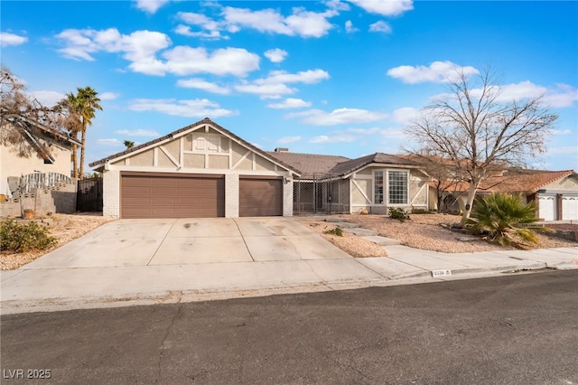 view of front of house featuring a gate, an attached garage, fence, and driveway