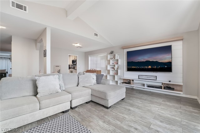 living room featuring lofted ceiling with beams, visible vents, and wood tiled floor