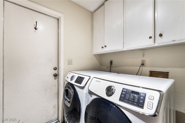 washroom with cabinet space and washing machine and dryer