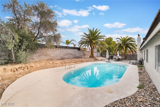 view of swimming pool with a patio area and a fenced backyard