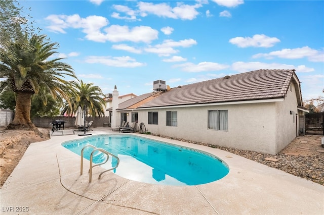 view of pool featuring a fenced backyard, central air condition unit, a fenced in pool, and a patio