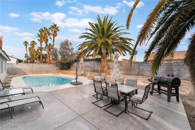 view of swimming pool with outdoor dining area, a patio, a fenced backyard, a grill, and a fenced in pool