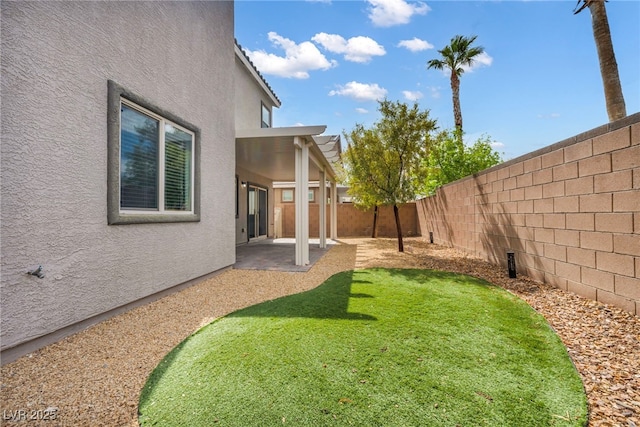 view of yard featuring a patio area and a fenced backyard