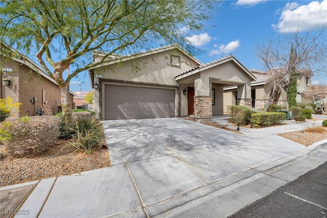 view of front of property with concrete driveway, a tile roof, stucco siding, a garage, and stone siding