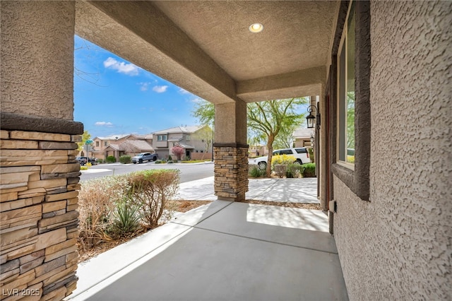 view of patio featuring covered porch and a residential view