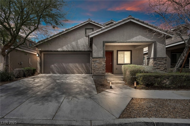 view of front facade featuring stone siding, stucco siding, driveway, and an attached garage