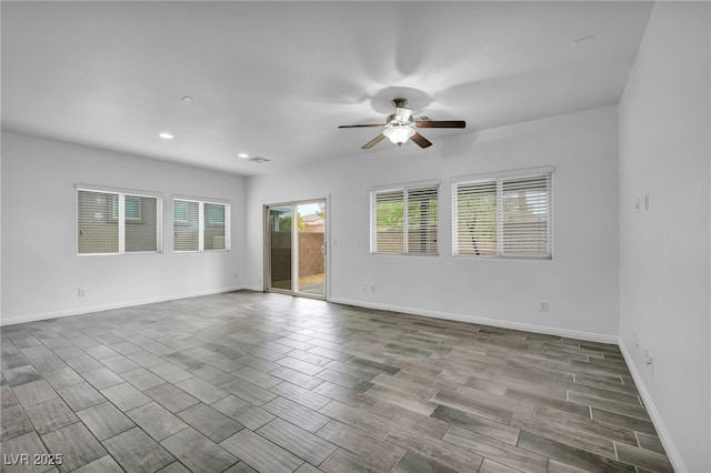 spare room featuring recessed lighting, baseboards, ceiling fan, and wood finished floors