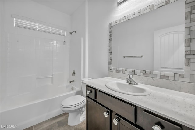 full bathroom featuring toilet, shower / washtub combination, wood finished floors, and vanity