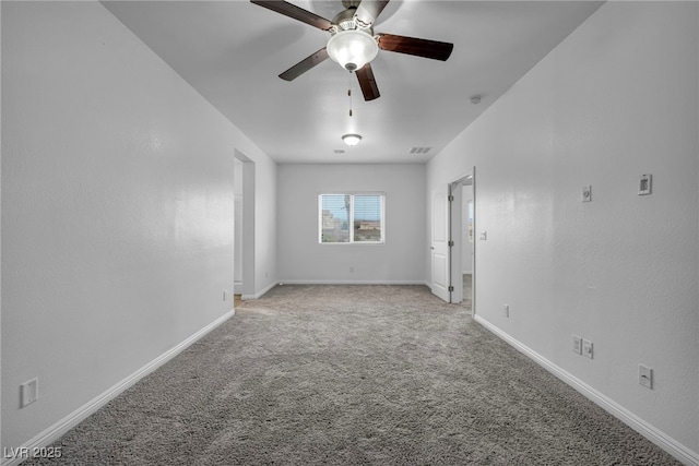 empty room with light carpet, visible vents, baseboards, and ceiling fan