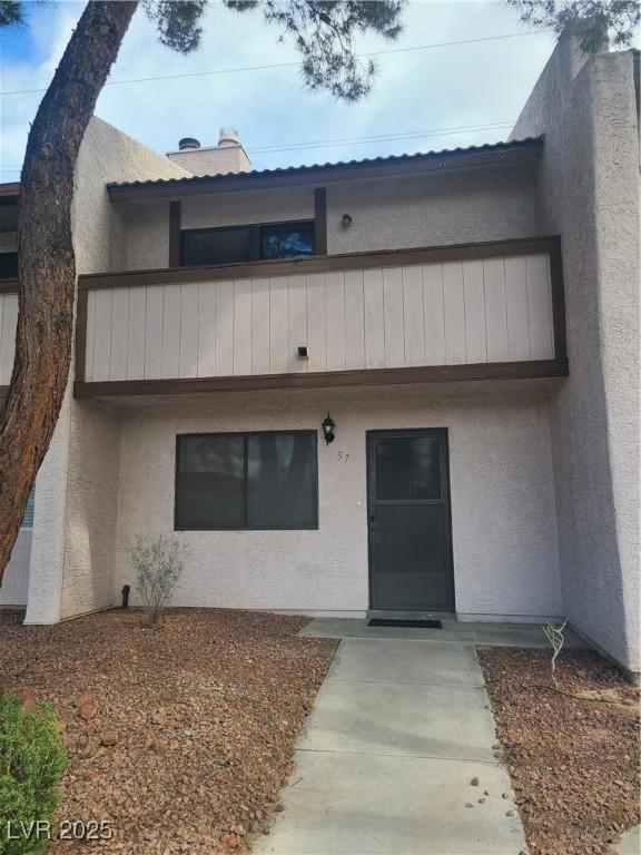 exterior space featuring a balcony and stucco siding