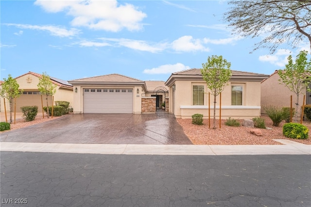 view of front of house featuring a gate, driveway, an attached garage, stucco siding, and a tile roof