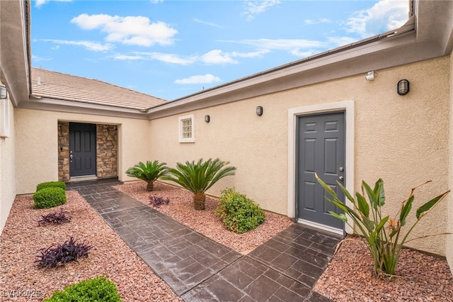 entrance to property featuring stucco siding