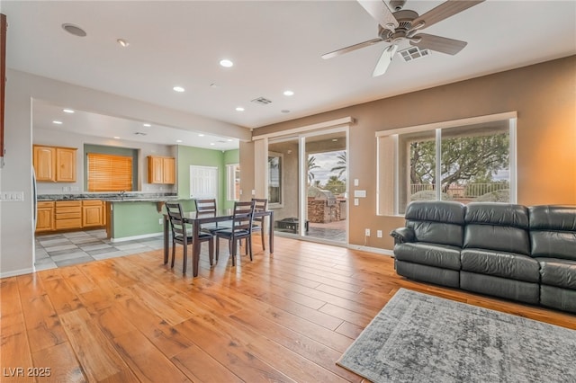 dining space with recessed lighting, visible vents, baseboards, and light wood-style floors