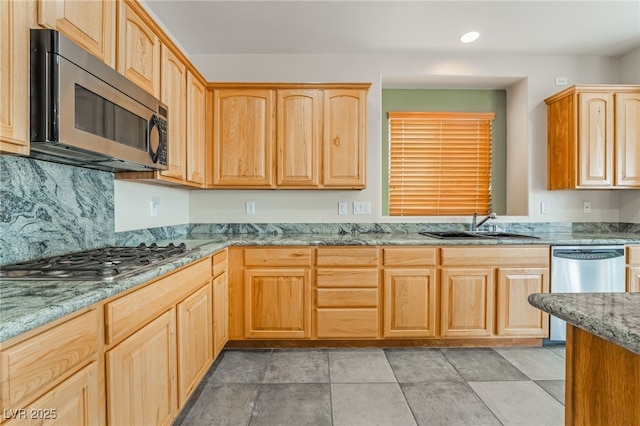 kitchen featuring light brown cabinets, a sink, recessed lighting, appliances with stainless steel finishes, and light stone countertops