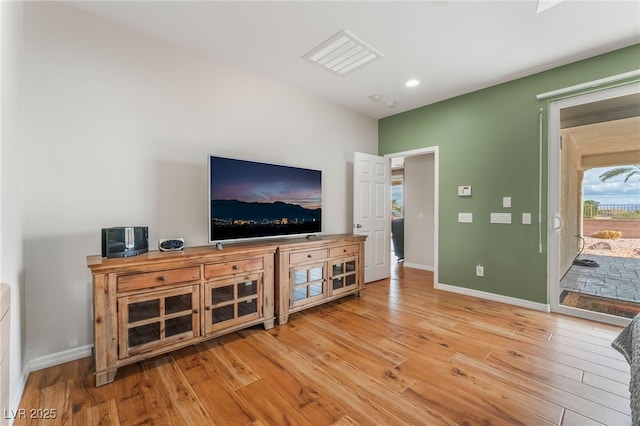 living area with recessed lighting, baseboards, and wood finished floors