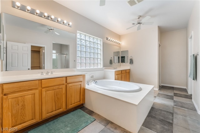 bathroom featuring visible vents, a shower stall, ceiling fan, a garden tub, and a sink