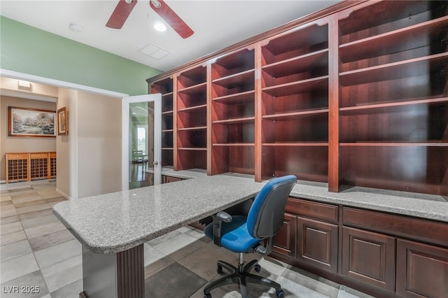 unfurnished office featuring visible vents, built in study area, and a ceiling fan