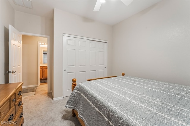 bedroom featuring a ceiling fan, baseboards, visible vents, a closet, and light carpet