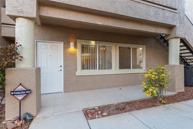 property entrance featuring stucco siding