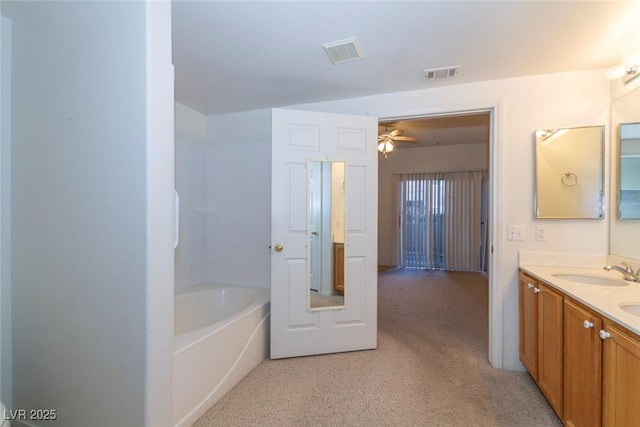 full bath featuring visible vents, a bathing tub, carpet floors, and a sink