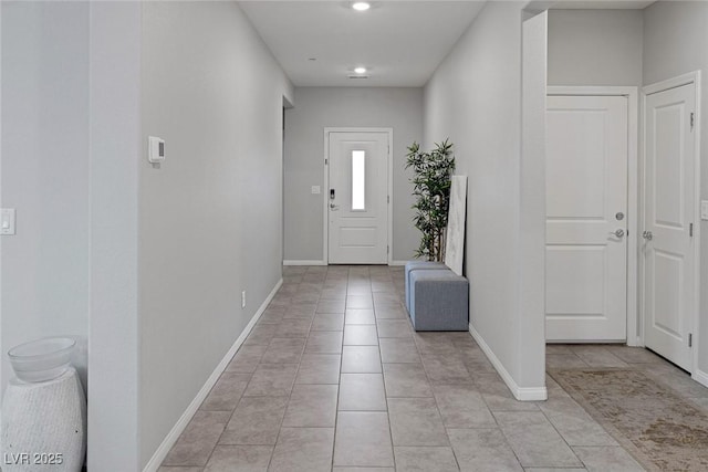 foyer featuring recessed lighting, baseboards, and light tile patterned flooring