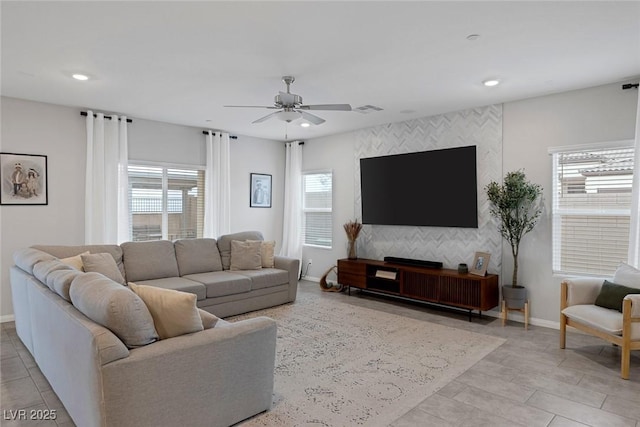 living area with visible vents, an accent wall, baseboards, ceiling fan, and recessed lighting