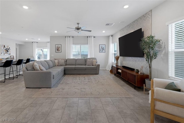 living room featuring recessed lighting, visible vents, a wealth of natural light, and a ceiling fan